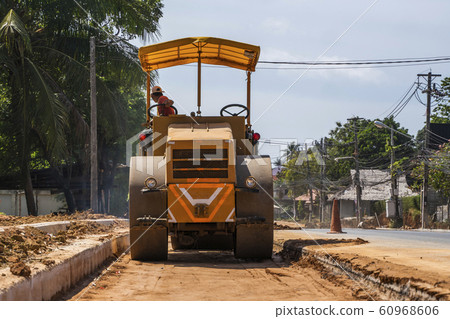 Road rollers working on the new roads construction site. Heavy duty machinery working on highway. Construction equipment. Compaction of the road. 60968606