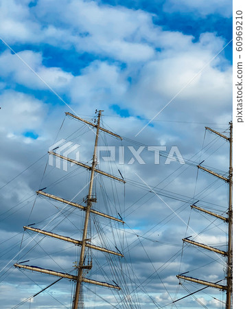 mast of a wooden sailboat ship against a blue sky mast of a wooden sailboat ship against a blue sky 60969210