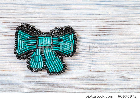 bow tie brooch from glass green bugles on gray bow tie brooch from glass green bugles on gray 60970972