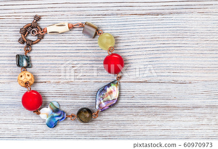 bracelet from nacre, bone and agate beads on gray 60970973