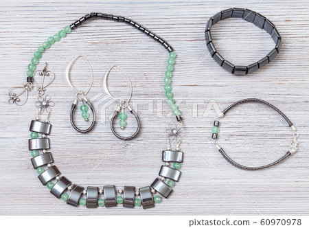 handmade necklace, earrings and bracelets on gray 60970978