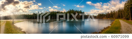 Panorama view at Wundschuher See in Wundschuh, Styria, Austria near Graz. View at forests and lake. 60971099