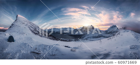 Hiking on snowy mountain range in sunrise on Segla 60971669