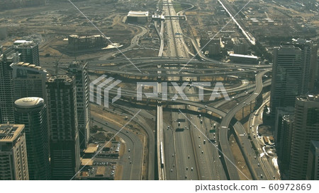 Aerial shot of a major circular road intersection 60972869