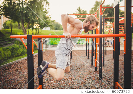 Fit Man Workout Out Arms On Dips Horizontal - Stock Photo