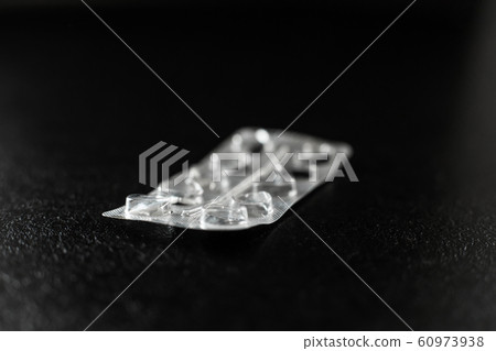 Empty blister from pills lies on the table 60973938