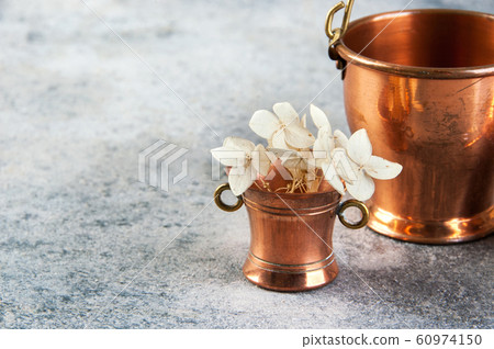Set of 3 copper miniatures on concrete background 60974150