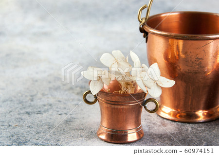 Set of 3 copper miniatures on concrete background 60974151