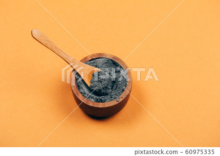 Grey clay with wooden spoon 60975335