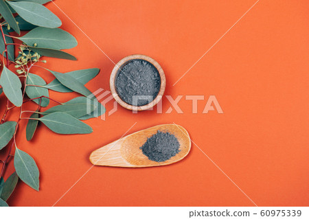 Grey clay with wooden spoon 60975339