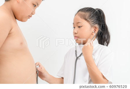 Little doctor is checking fat boy stomach with a 60976520