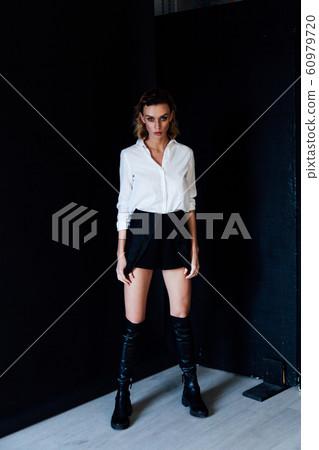 Portrait of a beautiful fashionable blonde woman in black white style dress 60979720