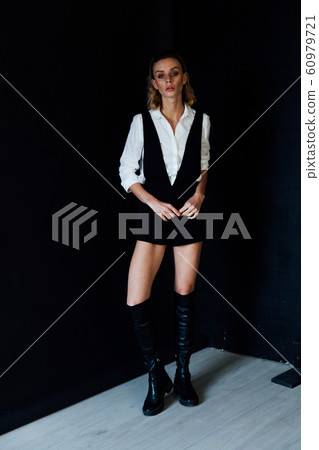 Portrait of a beautiful fashionable blonde woman in black white style dress 60979721