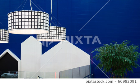 A bright blue wall, in front of it 3 round lamps. A bright blue wall, in front of it 3 round lamps. 60982091