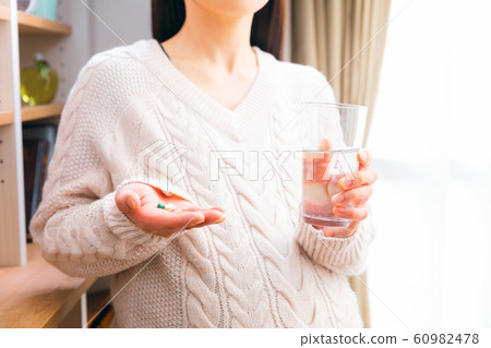 Pregnant woman taking medicine Pregnant woman taking medicine 60982478