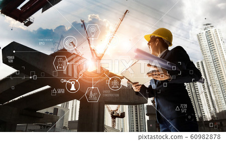 A futuristic architect, Industry 4.0.Engineer manager using tablet with icon network  60982878