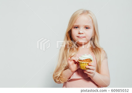 little girl eating cake with cream cupcake sweet little girl eating cake with cream cupcake sweet 60985032