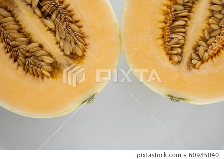Fresh sweet orange melon on the white plate as a background with a selective focusing. Useful and vitamin-rich food. Vegeterian. Fresh sweet orange melon on the white plate as a background with a selective focusing. Useful and vitamin-rich food. Vegeterian. 60985040