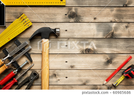 Work tools for carpenter on wooden background. 60985686