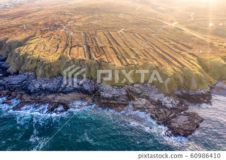 The coastline between Meenlaragh and Brinlack : Tra na gCloch in County Donegal - Ireland - Signs of massive peat harvesting The coastline between Meenlaragh and Brinlack : Tra na gCloch in County Donegal - Ireland - Signs of massive peat harvesting 60986410