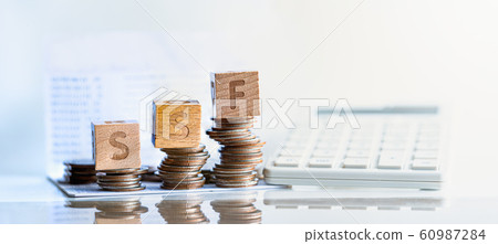 Wood block 2020 and coins in sack.  60987284