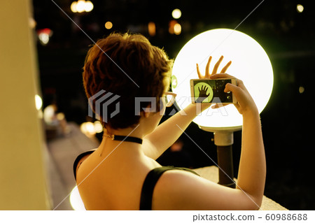 Young stylish girl in glasses with a short haircut making photo by phone 60988688