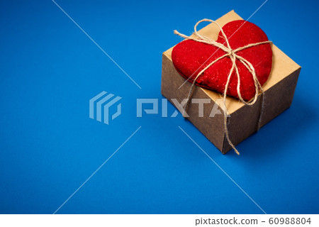 Red heart with a gift for Valentine's Day 60988804