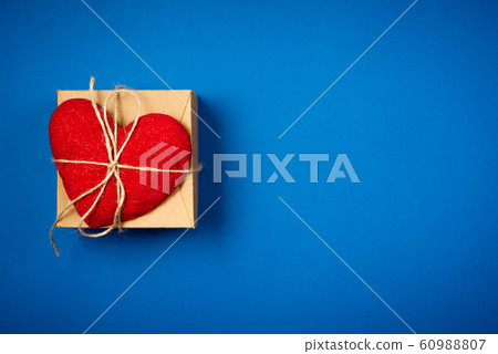 Red heart with a gift for Valentine's Day 60988807