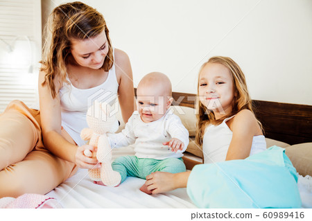 three girls sisters in the play in the bedroom in the morning love three girls sisters in the play in the bedroom in the morning love 60989416