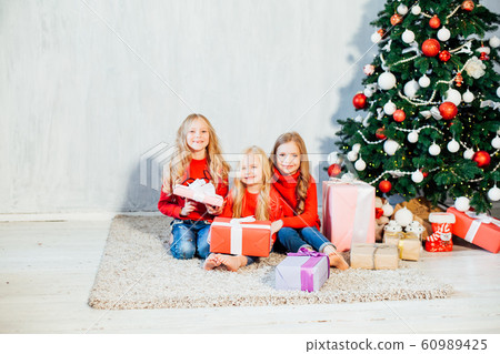three girls blonde sisters girlfriends gift new year tree holiday Christmas three girls blonde sisters girlfriends gift new year tree holiday Christmas 60989425