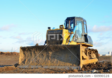 Bulldozer during of large construction jobs at building site. 60990128