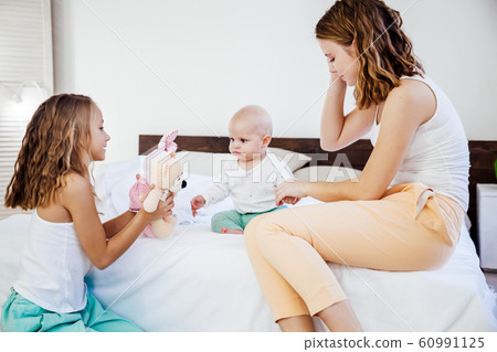 three girls sisters in the play in the bedroom in the morning love three girls sisters in the play in the bedroom in the morning love 60991125