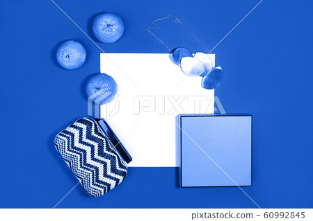 Female fashion layout with white paper sheet, orange tangerines and female accessories on classic 60992845