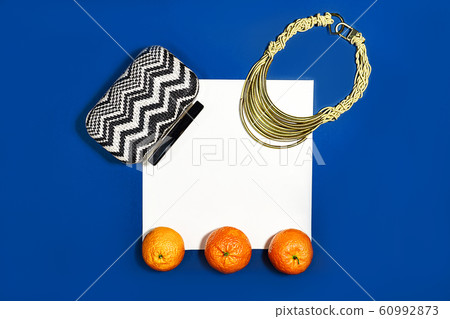 Female fashion layout with white paper sheet, orange tangerines and female accessories on classic Female fashion layout with white paper sheet, orange tangerines and female accessories on classic 60992873