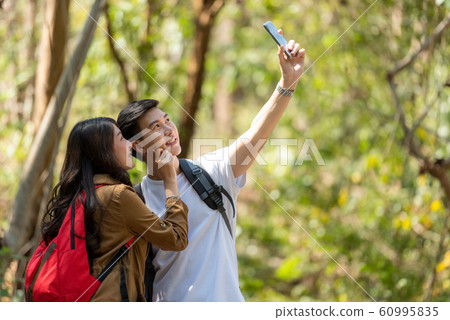 Tourist and traveler asian couple backpack enjoy  60995835