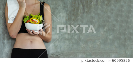 Lifestyle women hold fresh salad after exercise   60995836