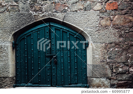a large door in the old stone wall a large door in the old stone wall 60995877