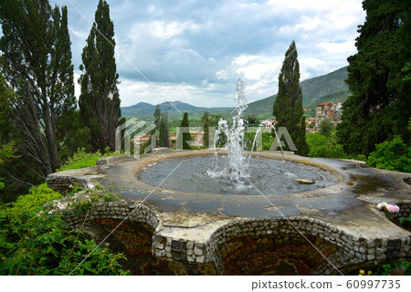 A beautiful Sensenmiya fountain pond under the blue sky. 60997735