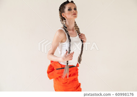 Portrait of a beautiful fashionable woman with braids dancing subculture 60998176