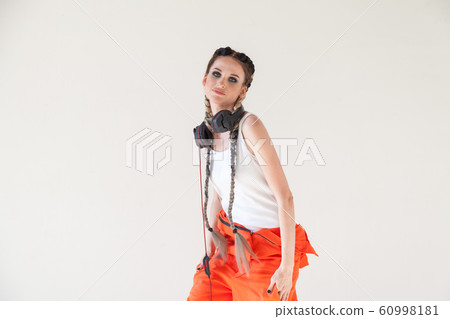 Portrait of a beautiful fashionable woman with braids dancing subculture 60998181