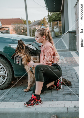 Young beautiful sports girl with fluffy German 60999006