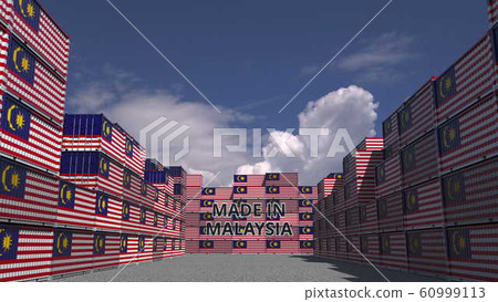 Cargo containers with MADE IN MALAYSIA text and national flags. Malaysian import or export related 3D rendering 60999113