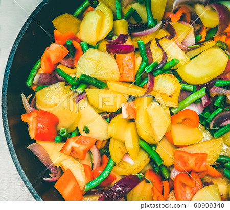 Closeup of stir-fry in wok with mixed vegetables Closeup of stir-fry in wok with mixed vegetables 60999340