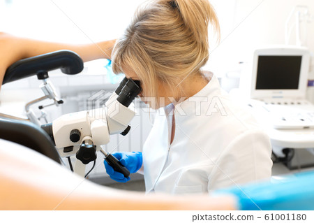 A gynecologist is examined by a patient who is A gynecologist is examined by a patient who is 61001180
