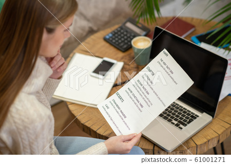 Cafe owner creating a menu for her restaurant 61001271