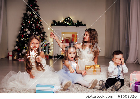 the little boy and three girls open Gifts Christmas new year tree Garland 61002320