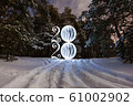 2020 written on the air with glowing ball at the background of winter forest 61002902