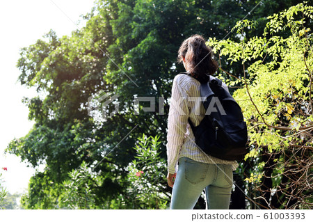 Beautiful woman smile portrait and walking relaxation at the garden in holiday weekend. 61003393