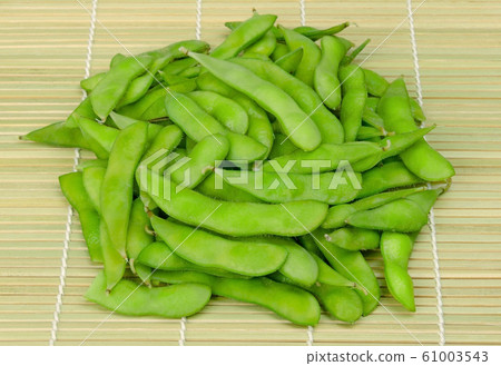 Pile of boiled edamame, green soybeans, maodou, on a bamboo mat Pile of boiled edamame, green soybeans, maodou, on a bamboo mat 61003543