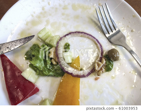 leftovers of a salad on table 61003953